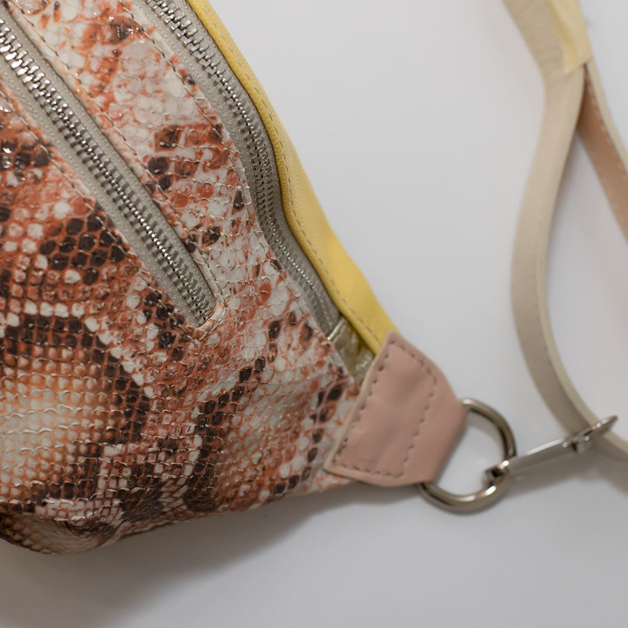 Close-up image of Ava crossbody bag in Tuscan Honey featuring snakeskin Italian leather and silver hardware