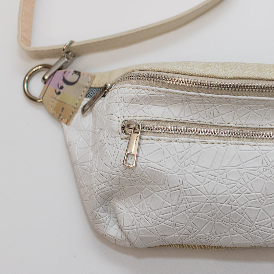 Close-up image of Ava crossbody bag in Snowdrop featuring white geometric Italian leather and silver hardware