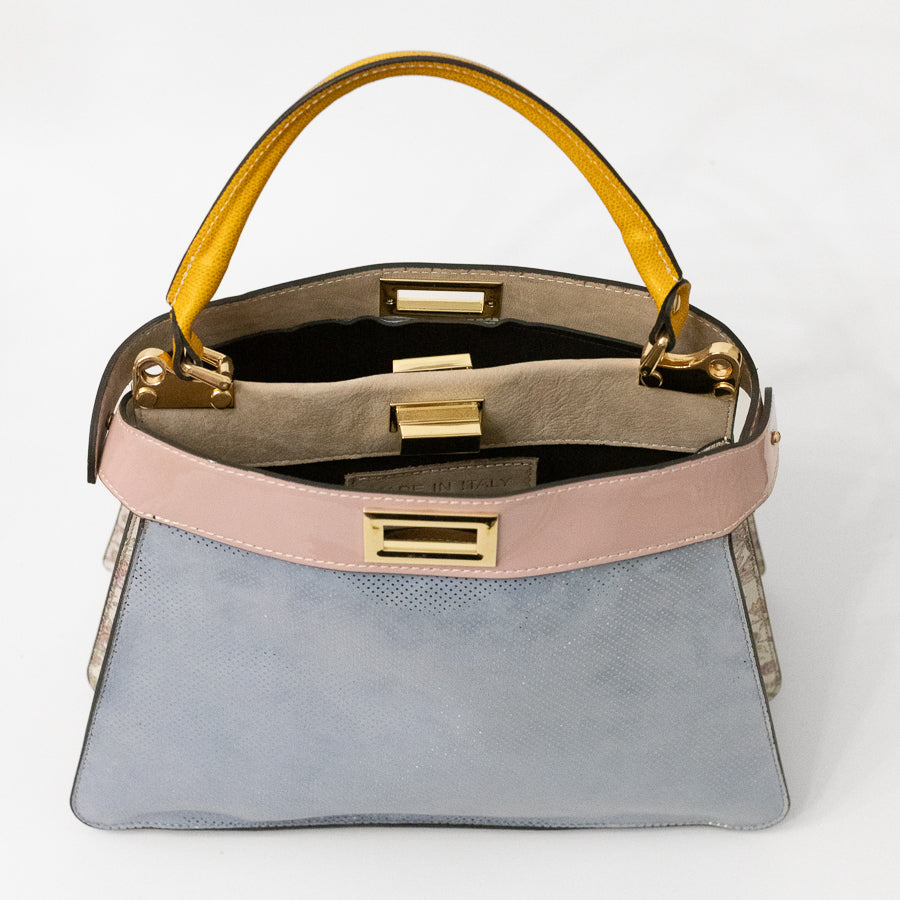 Interior image of Charlotte handbag in Cortona featuring dual structured compartments and opened gold turn-lock clasp