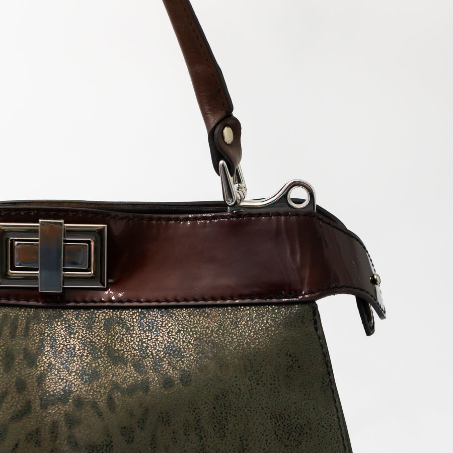 Close-up image of Charlotte handbag in Olive Grove featuring brown leather accent strip and silver hardware