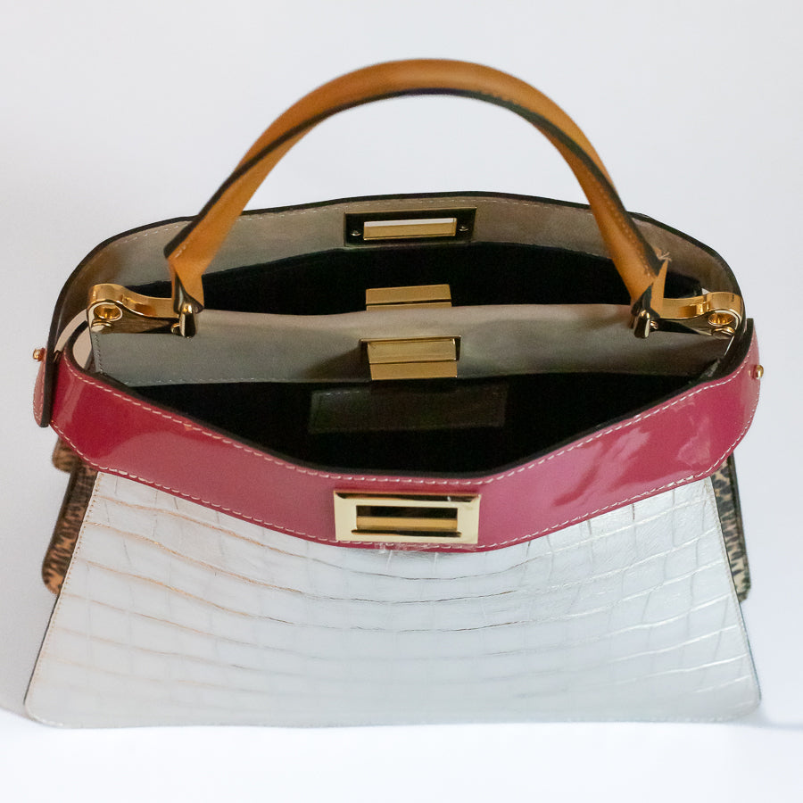 Interior image of Charlotte handbag in Villa Rosa featuring dual structured components and open turn-lock clasp