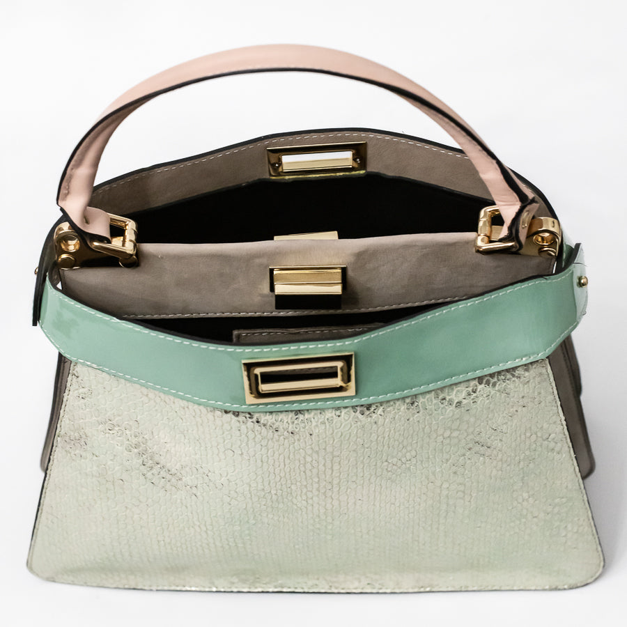 Interior image of Charlotte handbag in Sea Glass featuring dual structured compartments and opened turn-lock clasp