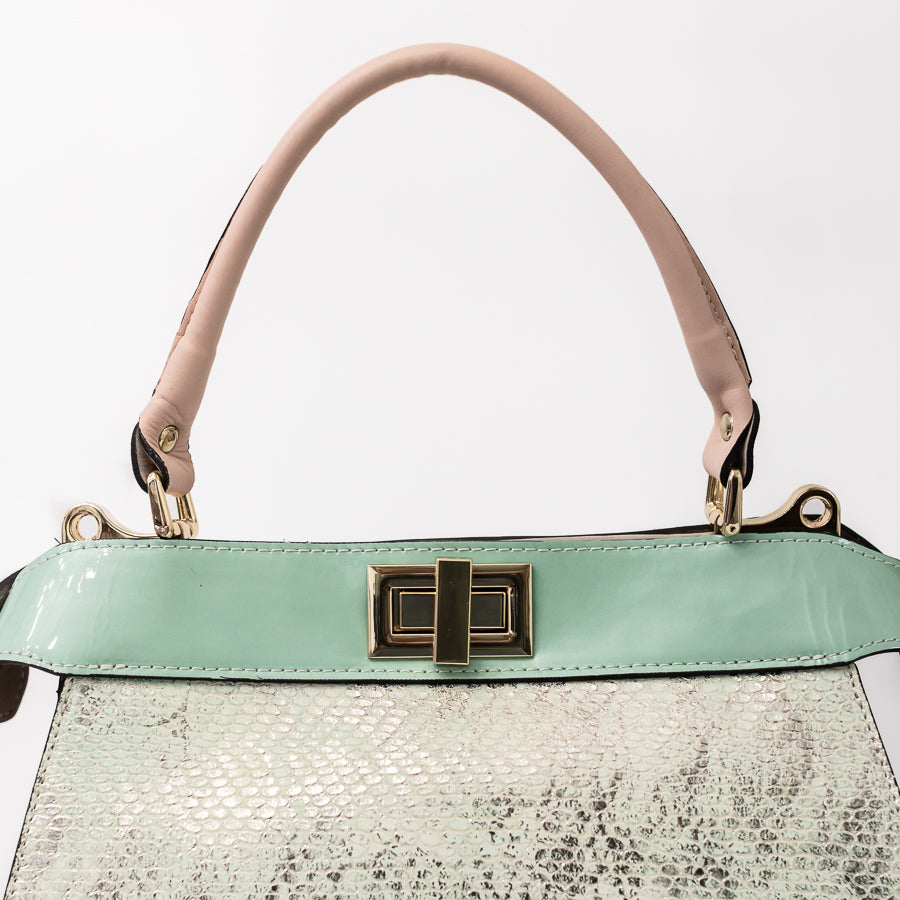 Close-up image of Charlotte handbag in Sea Glass featuring teal accent strip and gold hardware