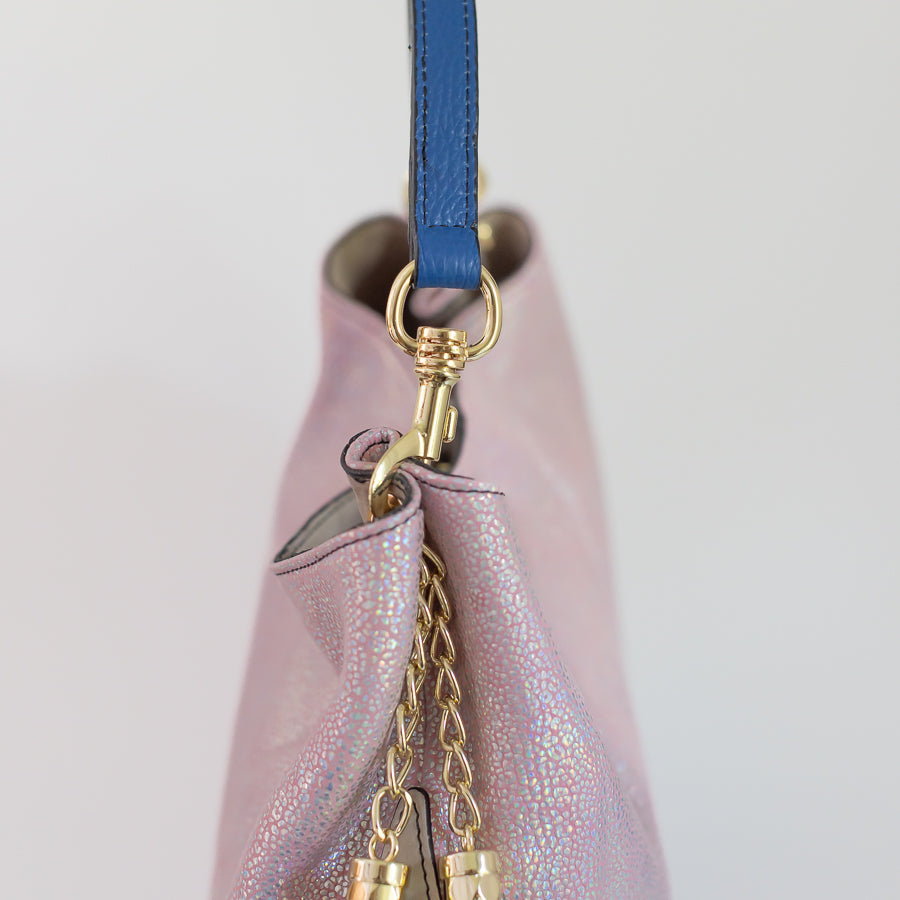 Close-up image featuring gold hardware and blue handle on the Lily handbag in the Moonstone