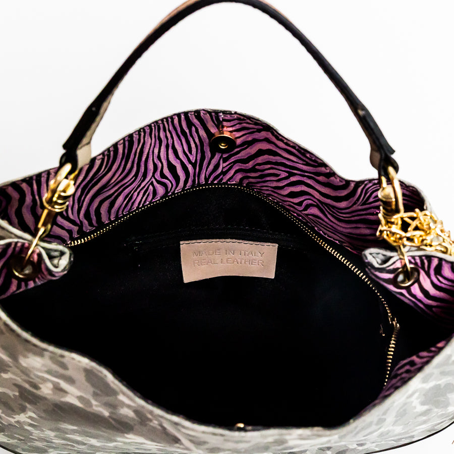 Interior image of Lily handbag in Petal Kiss featuring pink zebra leather and black interior