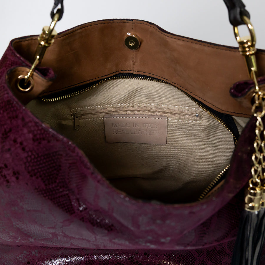 Interior close-up image of Lily handbag in Midnight Fig featuring gold zipper and smaller zipped pocket