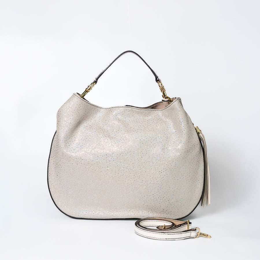 Lily handbag in Champagne Snow handcrafted in Italy featuring iridescent Italian leather and tassel detail