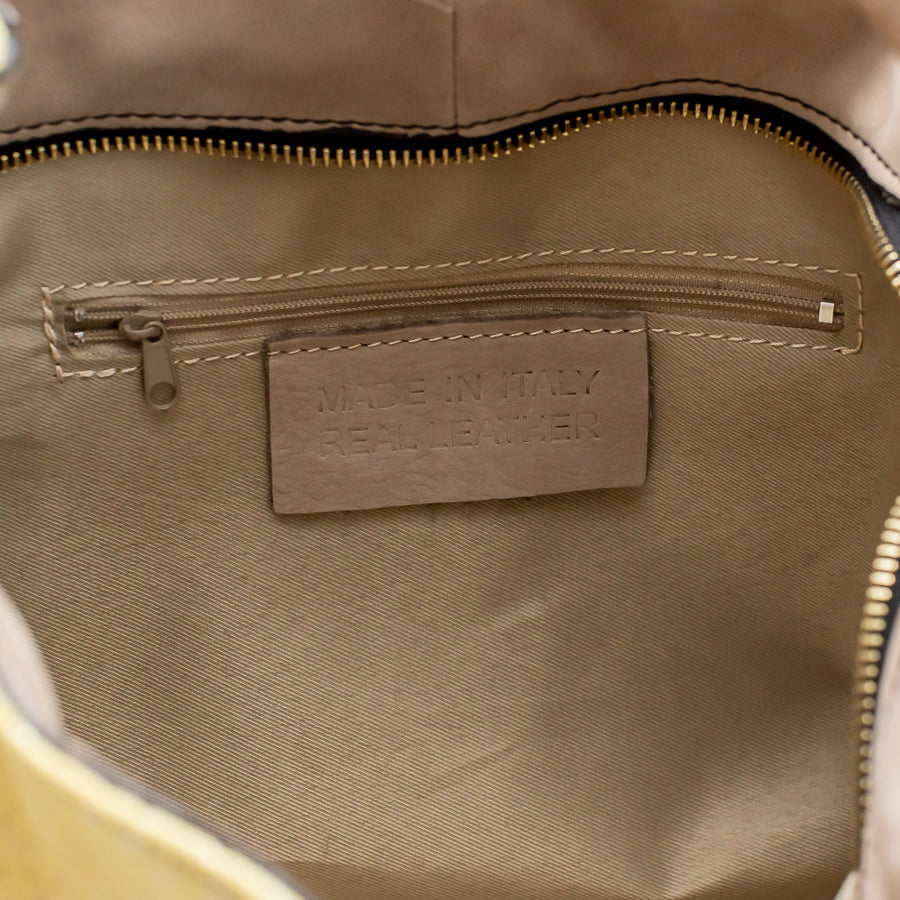 Interior image of Lily handbag Limoncello featuring interior zipped pocket and made in Italy real leather tag