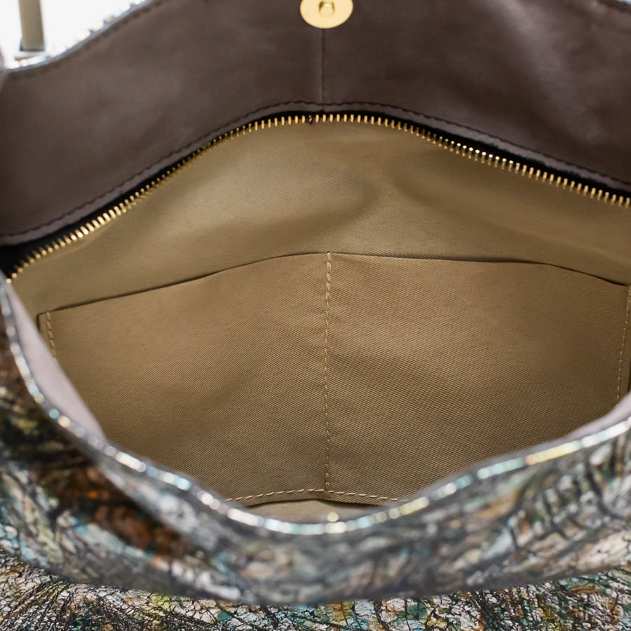 Interior view of Lily handbag in After Midnight featuring gold zipper and two interior pockets