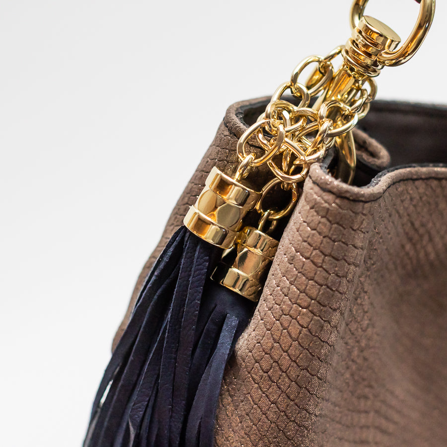 Close-up photo of Lily handbag in Golden Hour featuring textured leather and gold harware