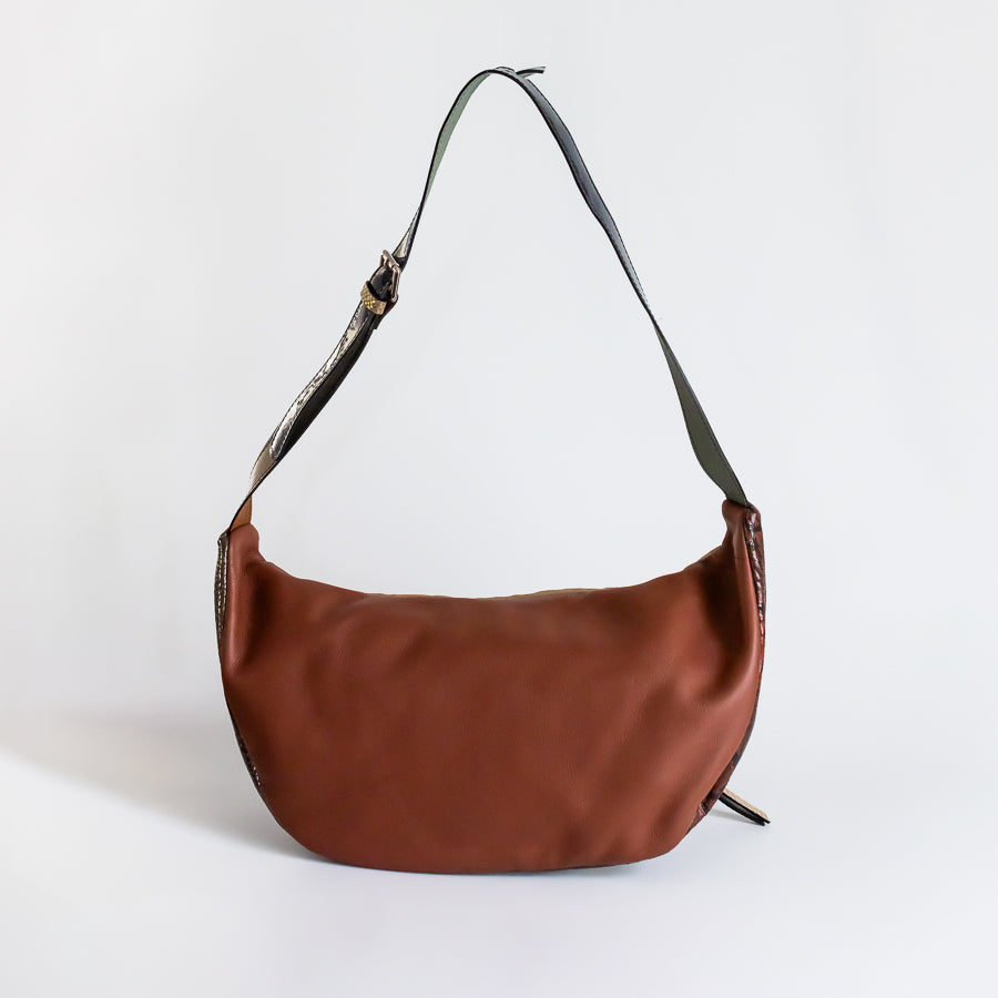 Behind view of Madeline crossbody bag in Sahara featuring brown Italian leather and adjustable strap