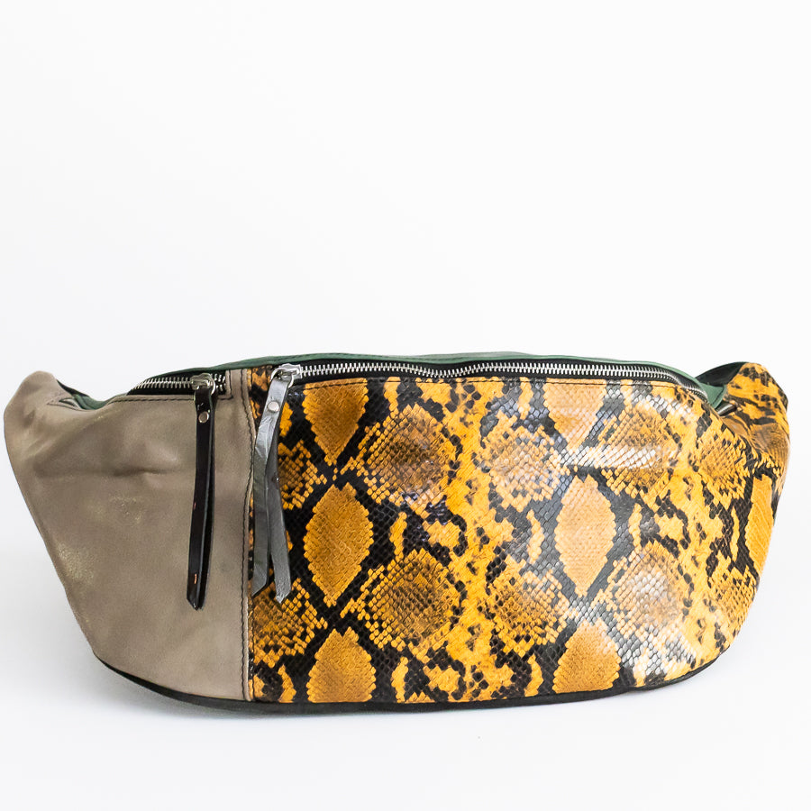 Standing image of Madeline crossbody bag featuring yellow snakeskin and silver zippers