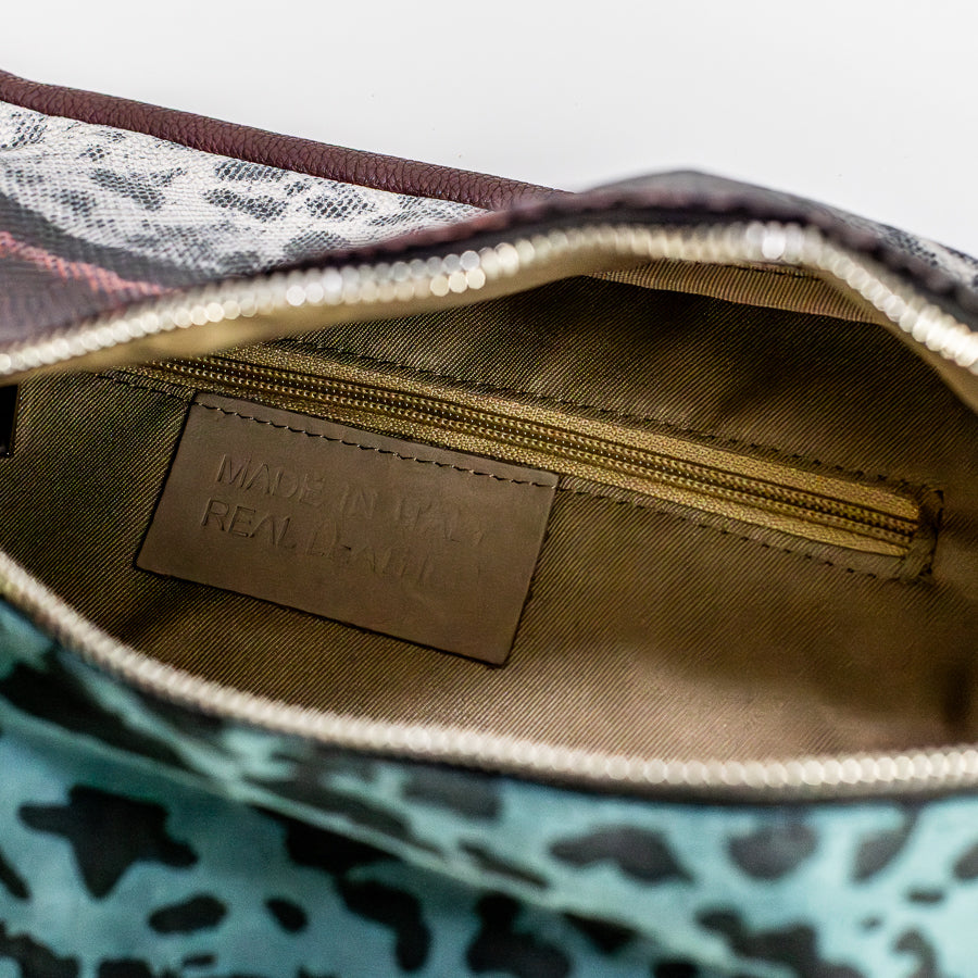 Interior view of Madeline crossbody bag in Laguna Felina featuring interior zipped pocket and made in Italy real leather tag