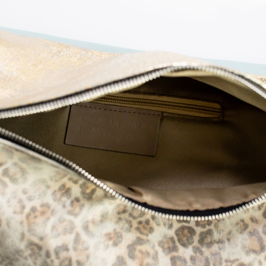 Interior image of Madeline crossbody bag in Caprielle featuring interior zipper and made in Italy real leather tag
