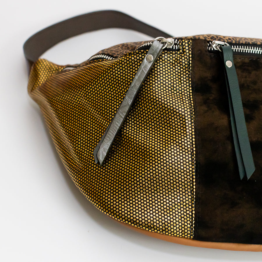 Close-up image of Madeline crossbody bag in Noir Jardin featuring shimmering gold Italian leather silver and green leather zippers