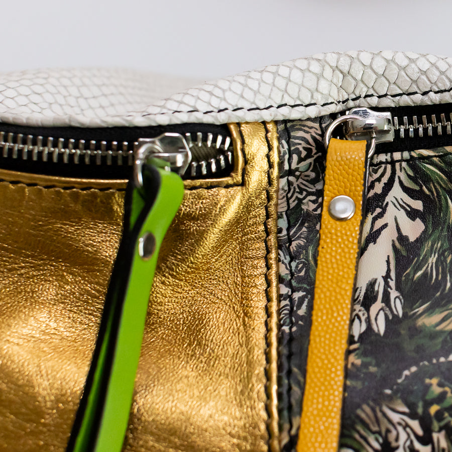 Close-up image of Madeline crossbody bag in Bengal featuring gold shimmering Italian leather and silver hardware