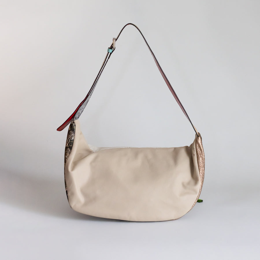 Back view of the Madeline crossbody bag in Midnight Bazaar featuring white leather and adjustable strap