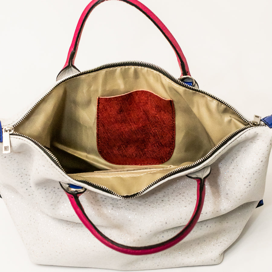 Interior image of Vera handbag in Winter Orchid featuring textured Italian leather interior pocket and silver zipper hardware