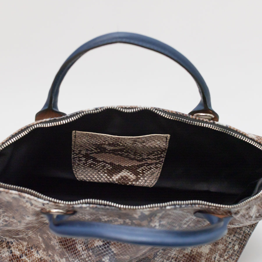 Interior image of Vera handbag in Desert Sands featuring matching snakeskin Italian leather interior pocket and gold zipper hardware