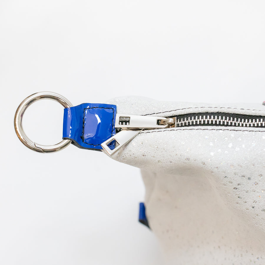 Close-up image of Vera handbag in Winter Orchid featuring silver zipper hardware and silver o-ring clasp