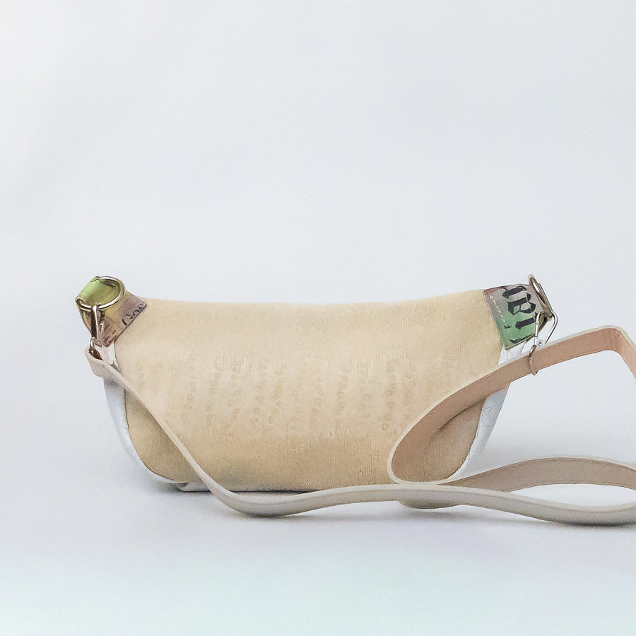 Back image of Ava crossbody bag in Snowdrop featuring gold Italian leather and silver o-ring hardware