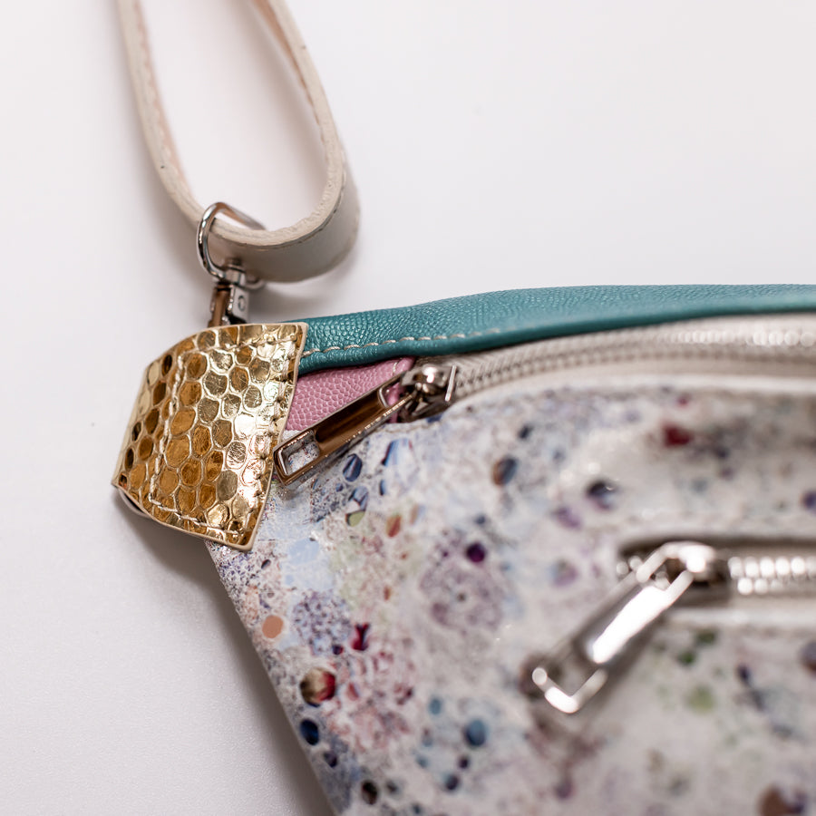 Close up image of Ava crossbody bag in Jubilee featuring gold textured Italian leather and silver hardware