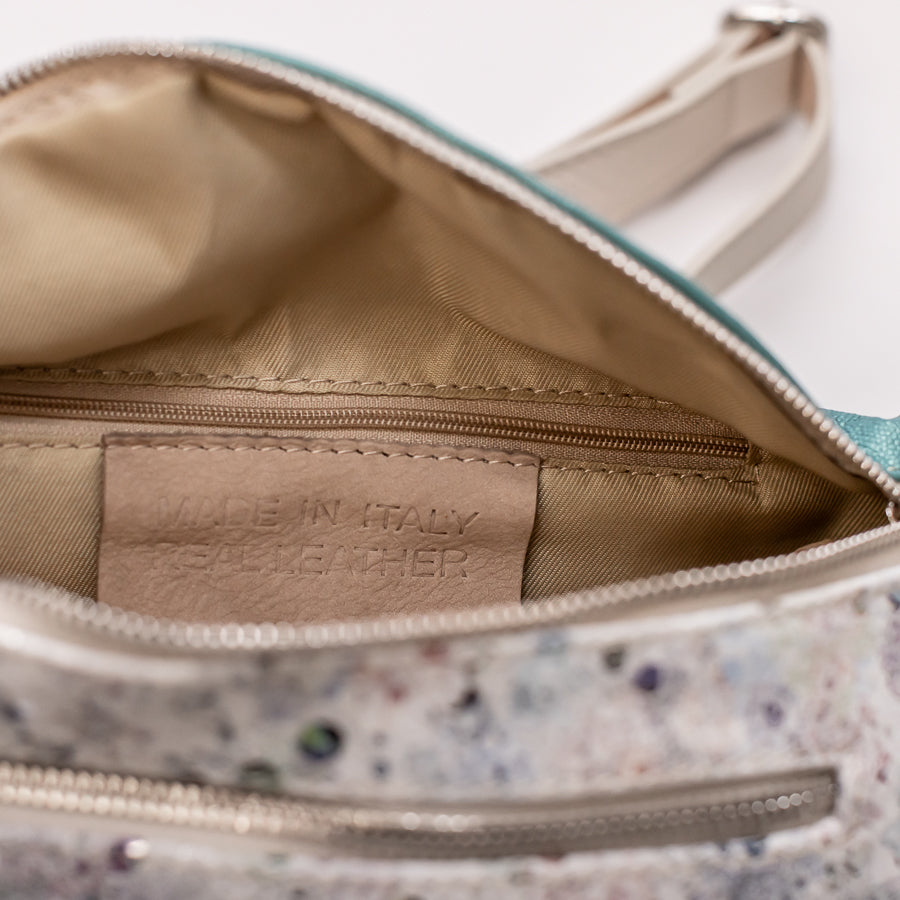 Interior image of Ava crossbody bag in Jubilee featuring interior zippered pocket and made in Italy real leather tag