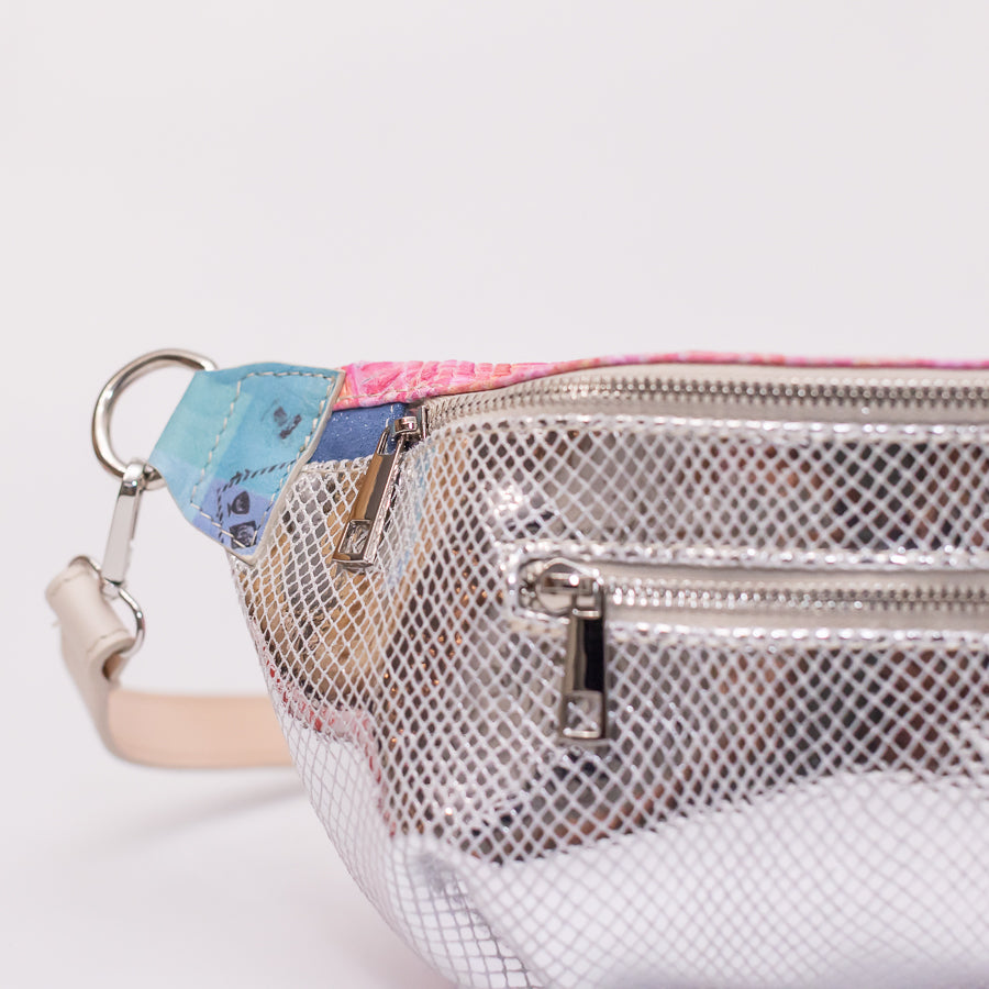 Close-up image of Ava crossbody bag in Electric Kiss featuring silver zipper hardware and o-ring