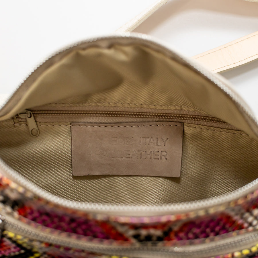 Interior image of Ava crossbody bag in Carnivale featuring interior zippered pocket and made in Italy real leather tag