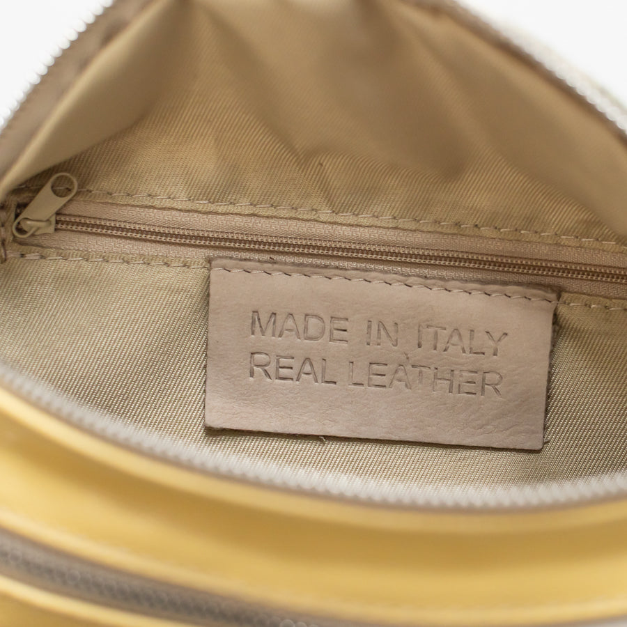 Interior image of Ava crossbody bag in Aureate featuring interior zippered pocket and made in Italy real leather tag