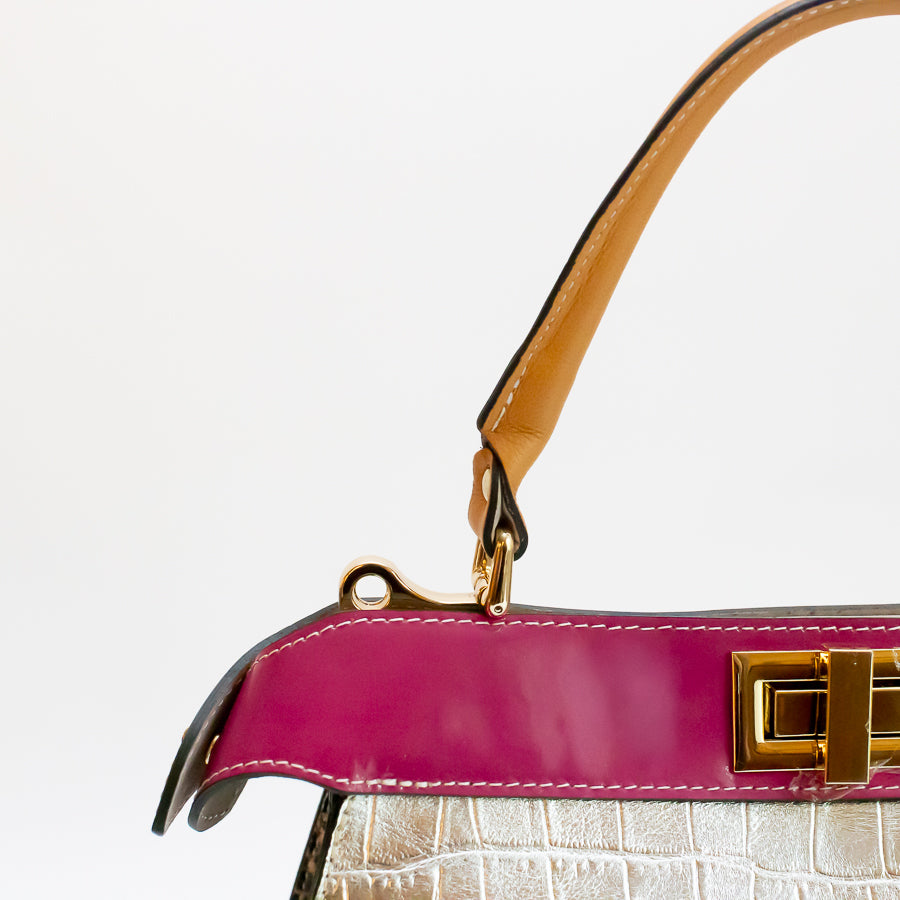 Close-up image of Charlotte handbag in Villa Rosa featuring pink accent trim and  orange structured top handle