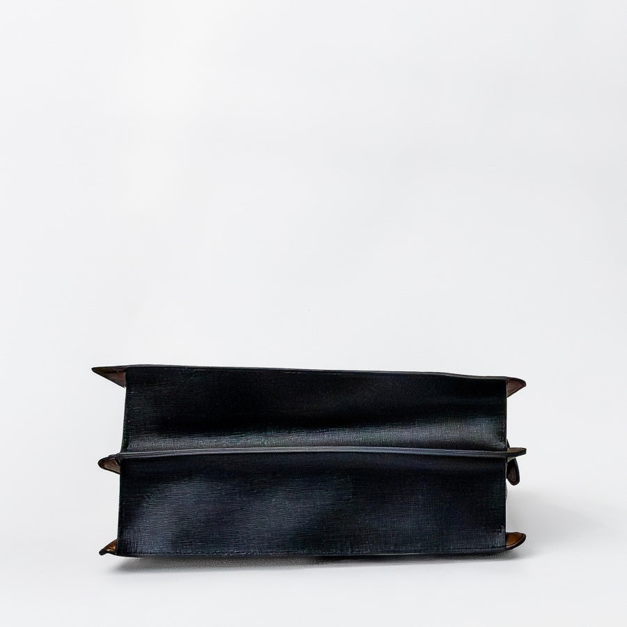 Bottom view of Charlotte handbag in Cypress featuring black textured Italian leather