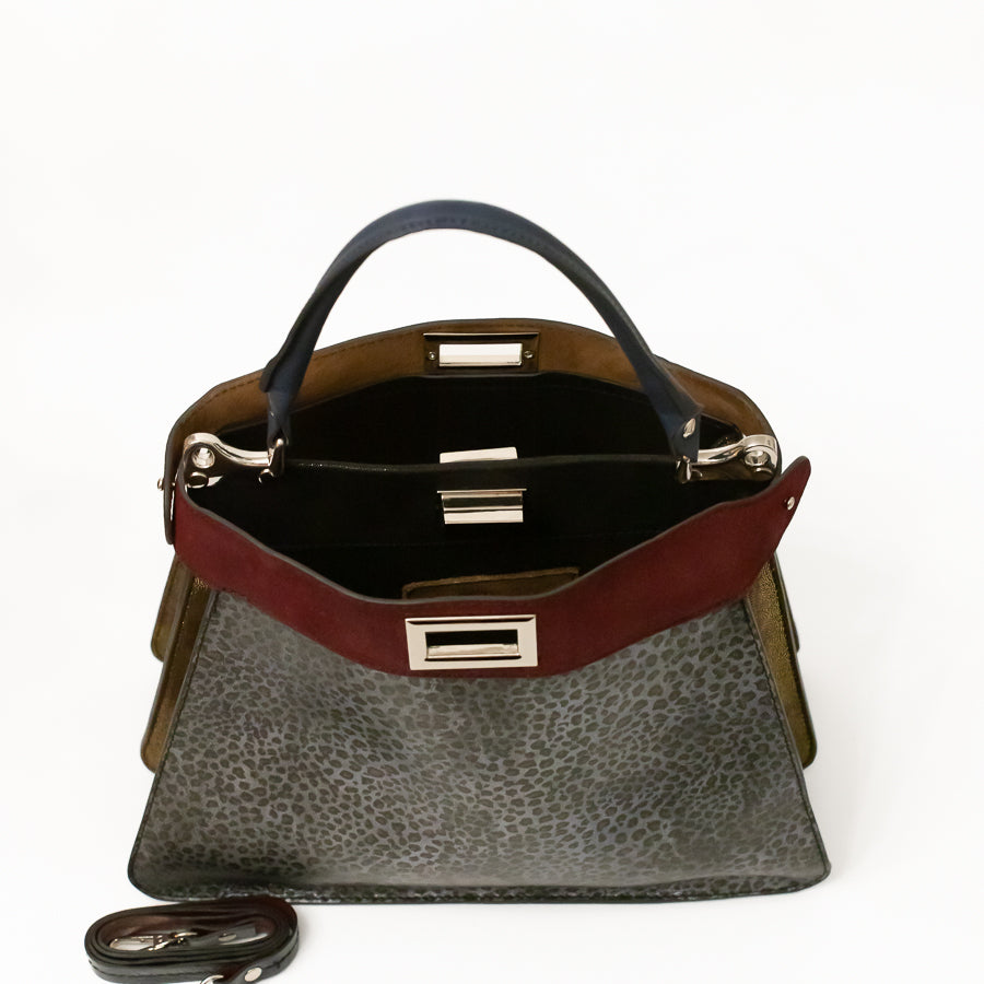 Interior image of Charlotte handbag in Argenta featuring dual structured compartments and opened turn lock clasp