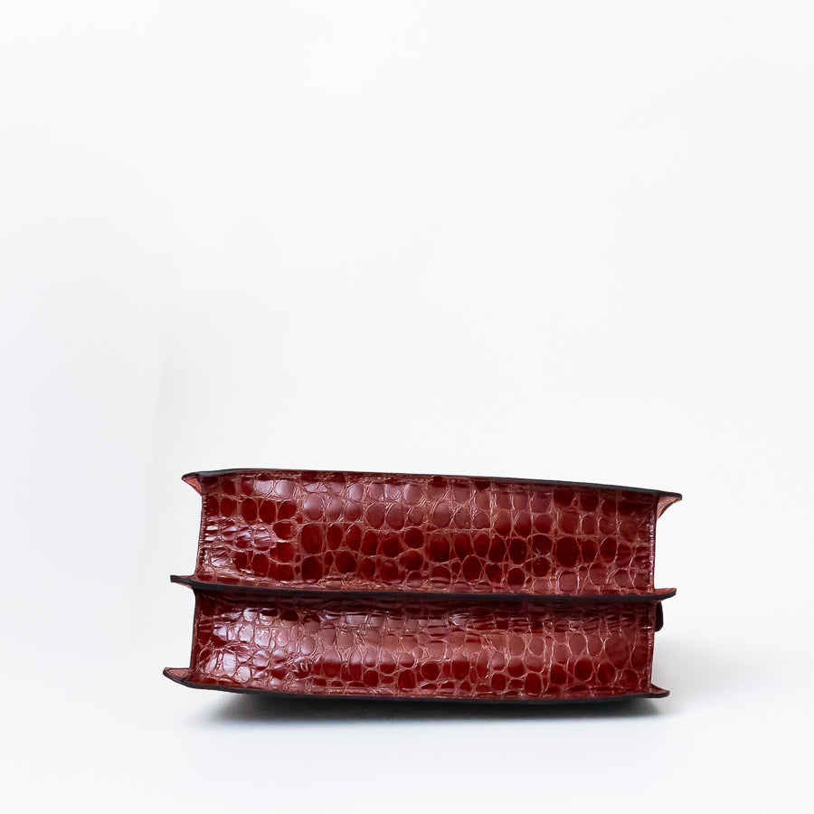 Bottom view of Charlotte handbag in Noir Palazzo featuring textured red Italian leather