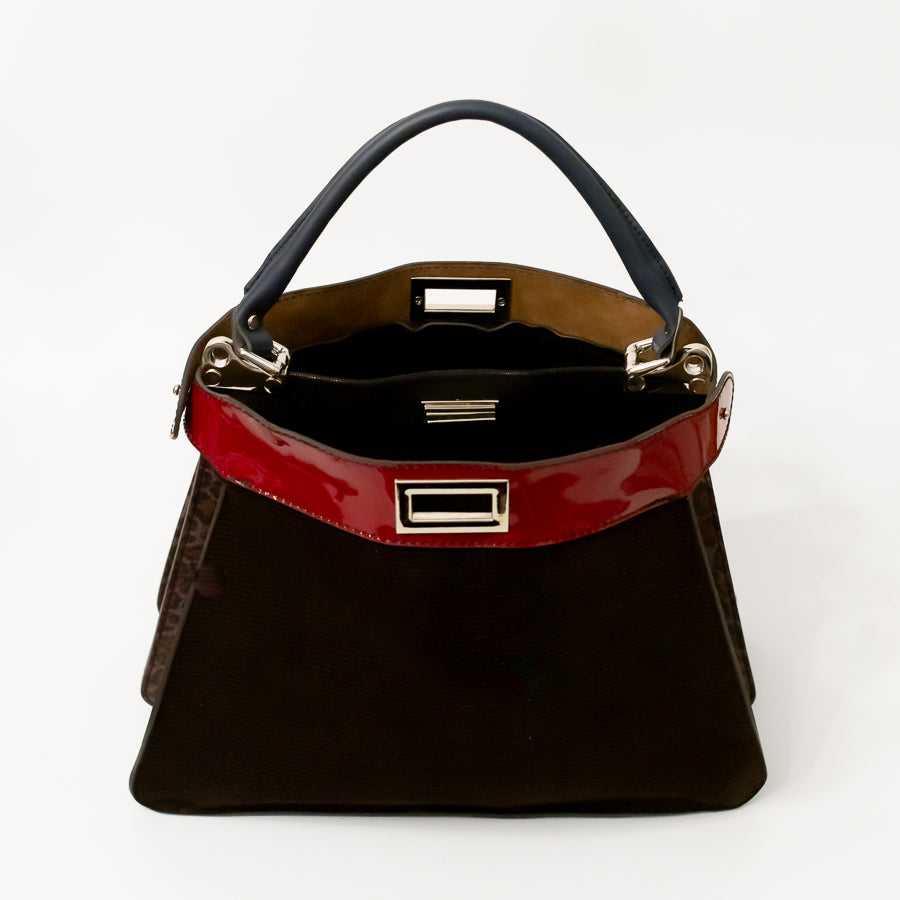 Interior image of Charlotte handbag in Belissima featuring dual structured compartments and opened turn-lock clasp