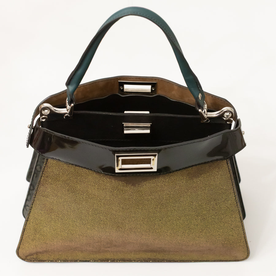 Interior image of Charlotte handbag in Afterglow featuring dual structured compartments and opened turn-lock clasp