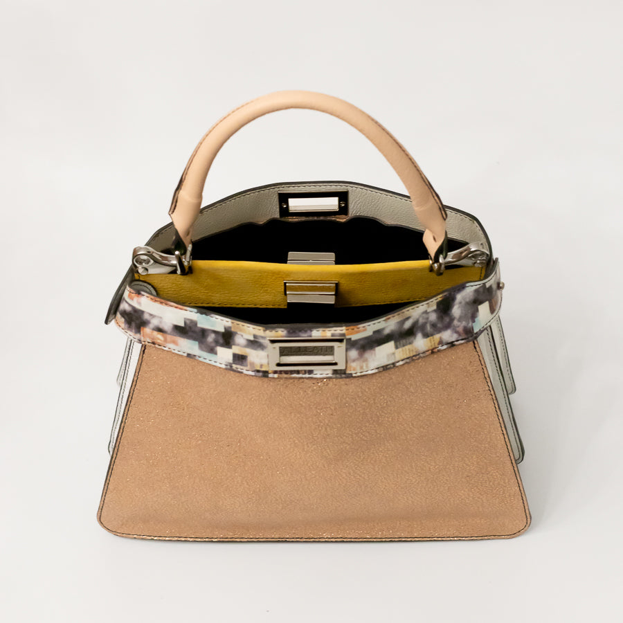 Interior image of Charlotte handbag in Champagne Piazza featuring dual structured compartments and opened turn-lock-clasp