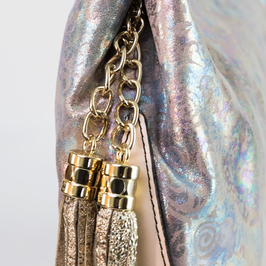 Close-up image of Lily handbag in Moon Garden featuring gold tassel and iridescent multicolored leather