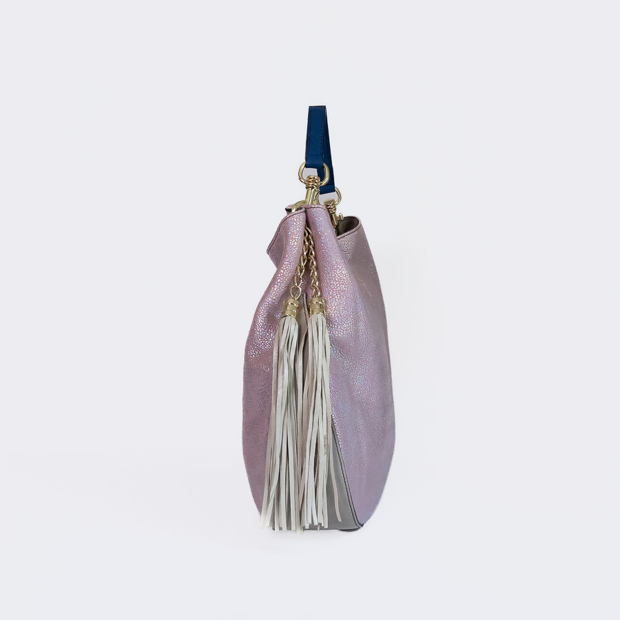 Side view of Lily handbag in Moonstone featuring beige and gold tassel