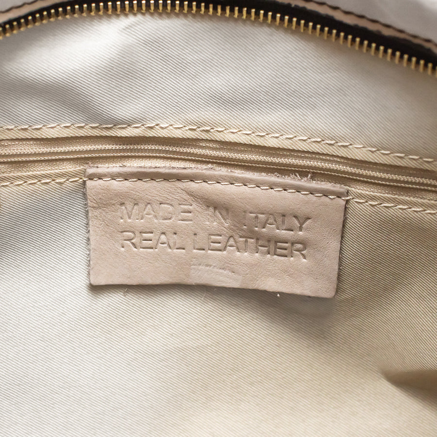 Interior view of Lily handbag in Rosé All Day featuring interior zippered pocket and real leather tag