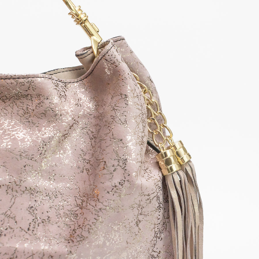 Close-up image of Lily handbag in Rosé All Day featuring gold hardware and iridescent silver and pink Italian leather