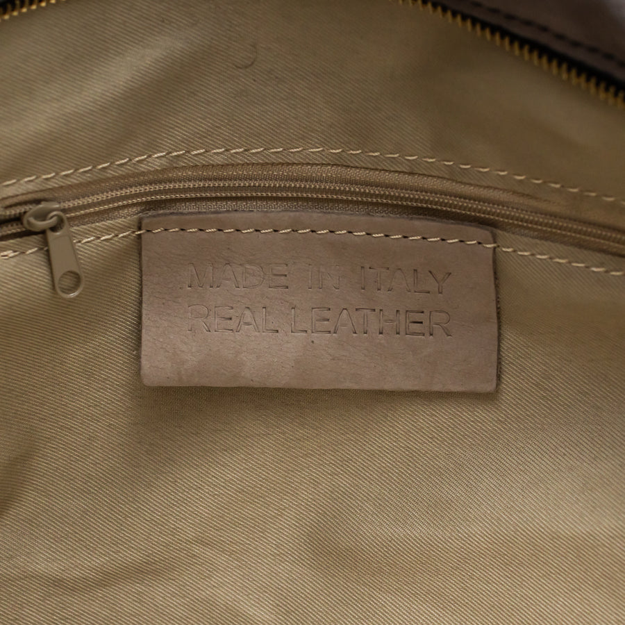 Interior image of Lily handbag in Golden Hour featuring interior zippered pocket and made in Italy real leather tag 