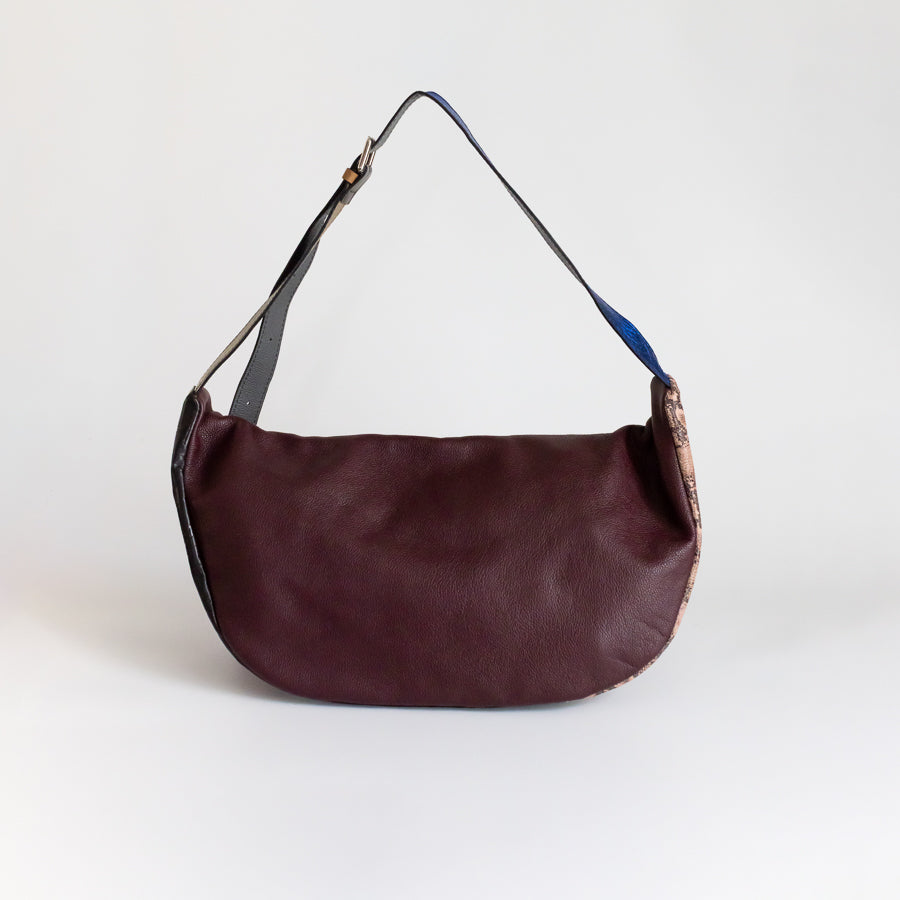 Behind view of Madeline crossbody bag in Monaco Jungle featuring brown Italian leather and adjustable strap