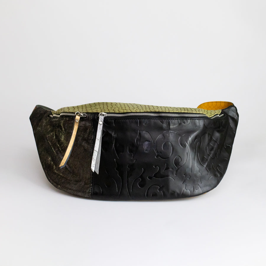 Standing image of Madeline crossbody bag in Verde Notee featuring carved black Italian leather and shimmering gold Italian leather