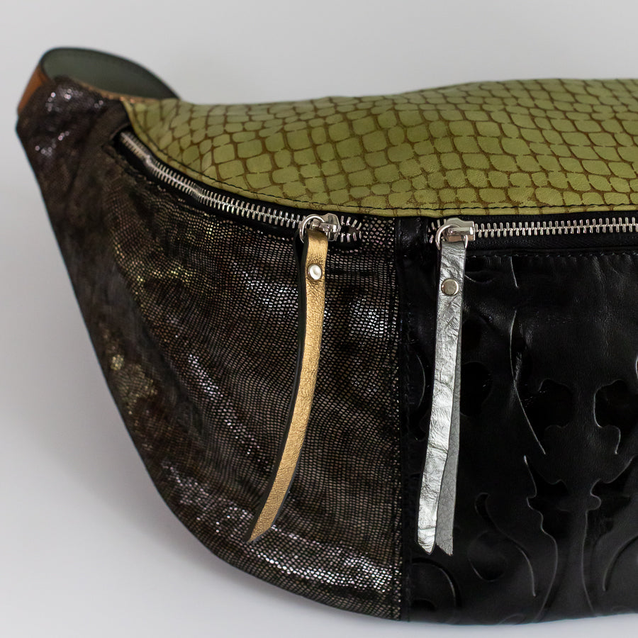 Close-up image of Madeline crossbody bag in Verde Notee featuring shimmering Italian leather and gold and silver leather zippers