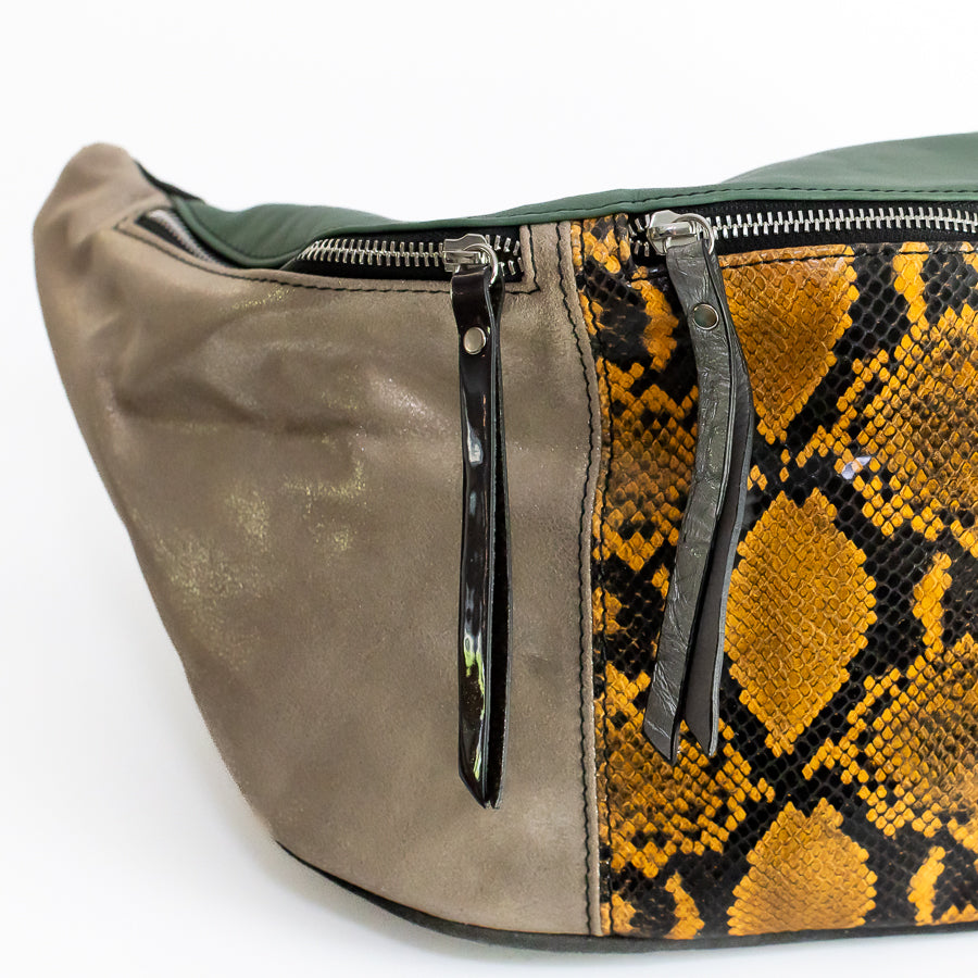 Close up image on Madeline crossbody bag in Ambra featuring iridescent Italian leather and iridescent leather zippers