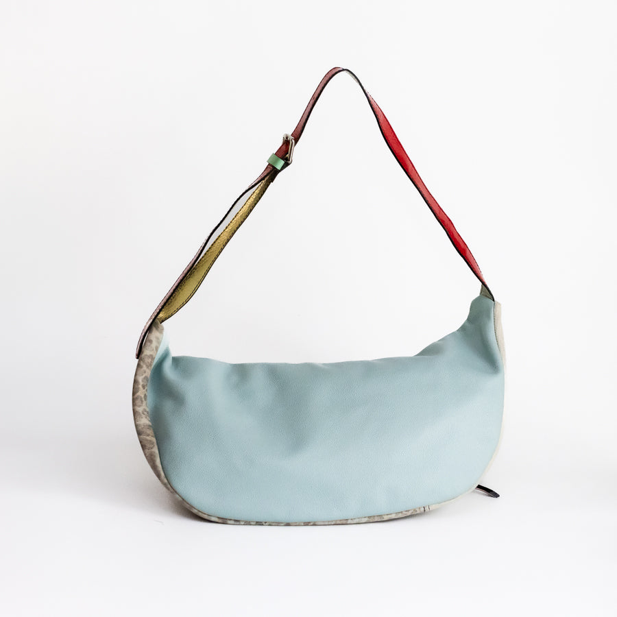 Back image of Madeline crossbody bag in Caprielle featuring light blue Italian leather and adjustable strap