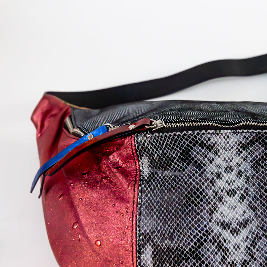 Close-up view of Madeline crossbody bag in Capri Nights featuring blue and red leather zippers