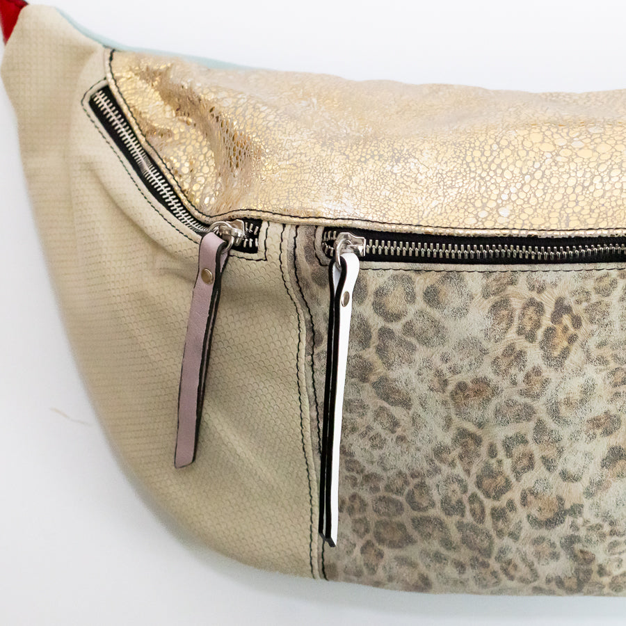 Close-up image of Madeline crossbody bag in Caprielle featuring snakeskin Italian leather and shimmering gold Italian leather