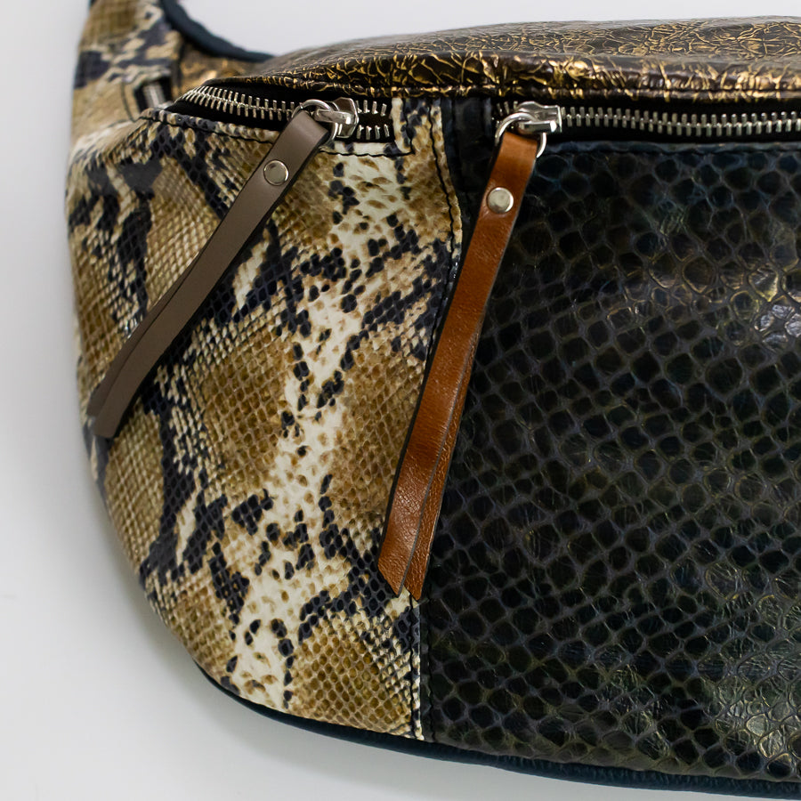 Close-up image of Madeline crossbody bag in Absinthe featuring different brown zippers and different snakeskin leathers